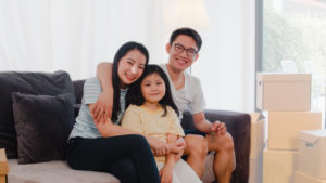 Happy Asian young family homeowners bought new house.